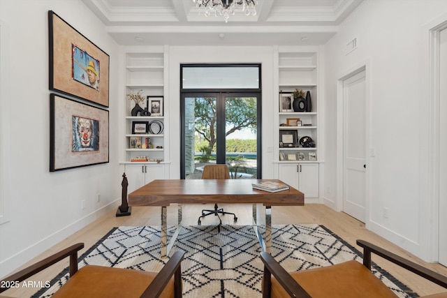 office area featuring built in shelves, ornamental molding, coffered ceiling, and light hardwood / wood-style flooring