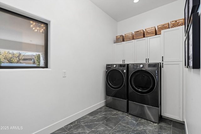 laundry room with cabinets and washing machine and dryer