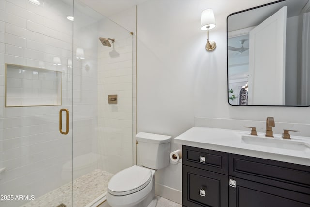 bathroom featuring vanity, toilet, and a shower with shower door