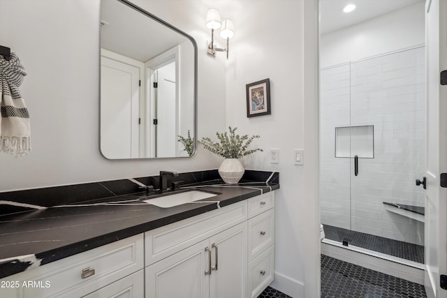 bathroom with walk in shower and vanity