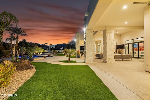 exterior space featuring ceiling fan, an outdoor hangout area, and a patio area