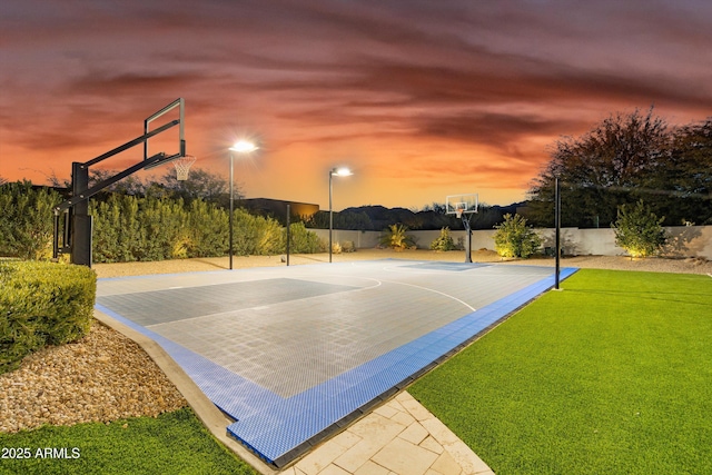 view of basketball court featuring a lawn