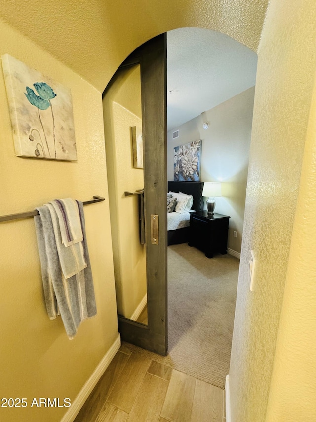bathroom with baseboards and wood finished floors
