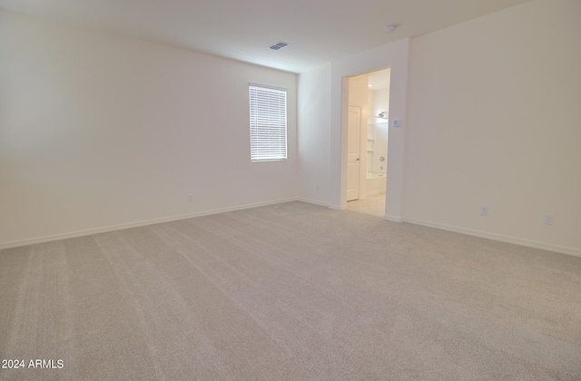 spare room with light carpet