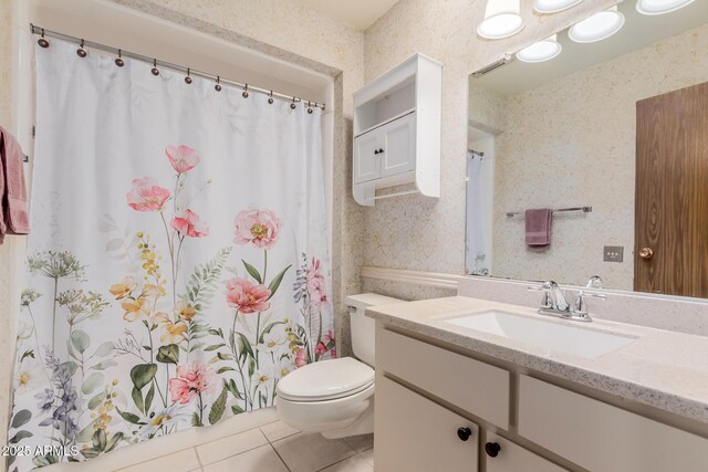 bathroom featuring tile patterned flooring, vanity, and toilet