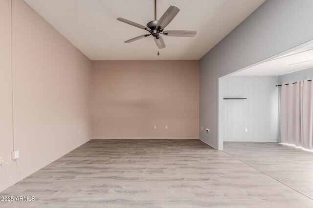 spare room with ceiling fan and light wood-type flooring