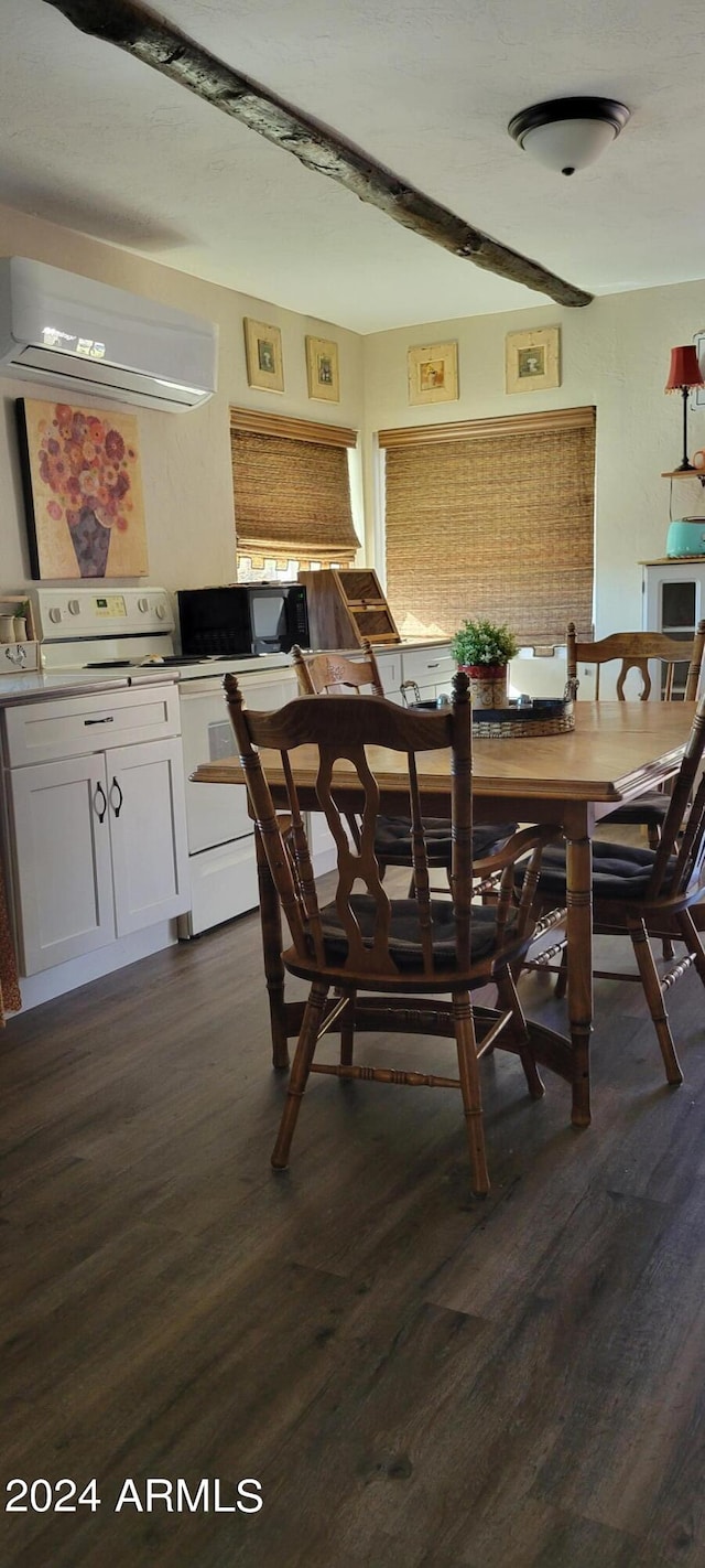 dining room with an AC wall unit and dark hardwood / wood-style floors