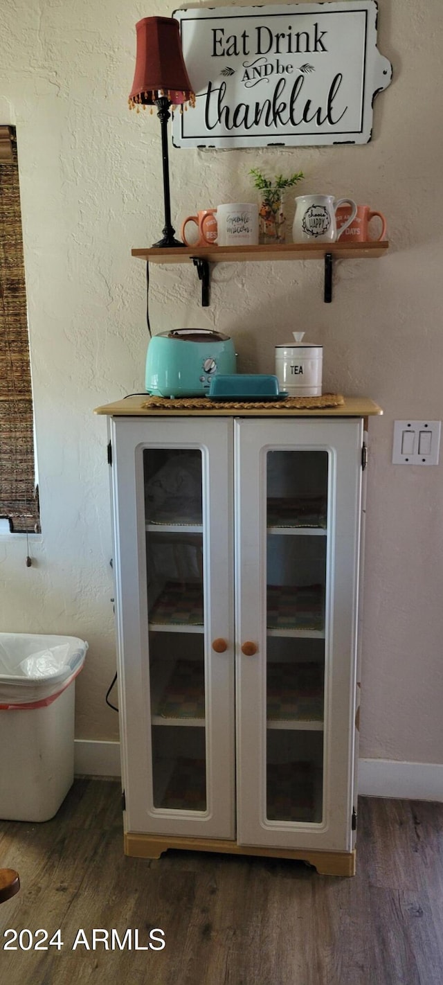 225 N Lobb Ave, Superior, AZ 85173 - bar with baseboards, wood finished floors, and beverage cooler