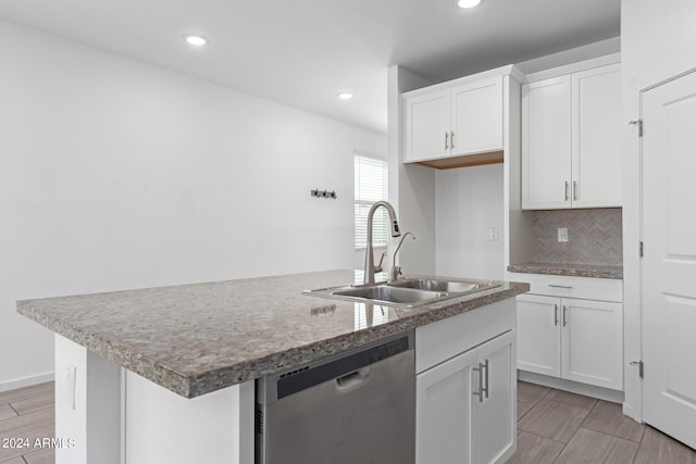 kitchen featuring dishwasher, an island with sink, tasteful backsplash, white cabinetry, and sink