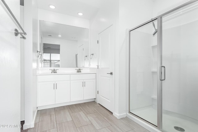 bathroom with walk in shower and vanity