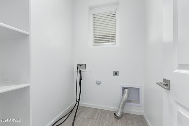 laundry room with electric dryer hookup, light hardwood / wood-style flooring, gas dryer hookup, and washer hookup