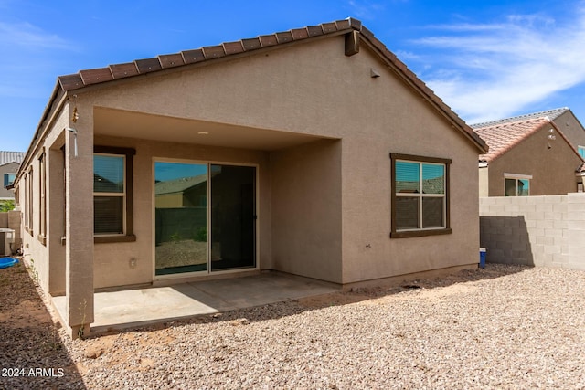 rear view of house featuring a patio and central AC unit