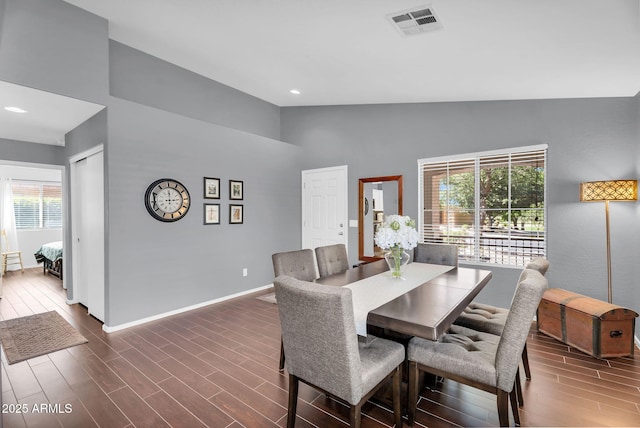 dining space featuring healthy amount of natural light, baseboards, dark wood-style flooring, high vaulted ceiling, and recessed lighting