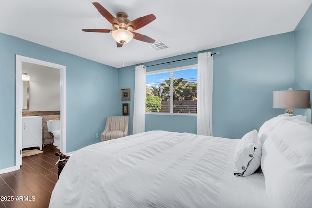 bedroom featuring dark wood-style flooring, a ceiling fan, and ensuite bath
