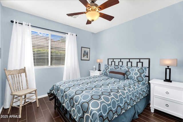 bedroom featuring wood tiled floors, baseboards, and ceiling fan