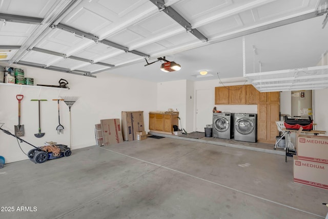 garage featuring washing machine and dryer, a garage door opener, and gas water heater