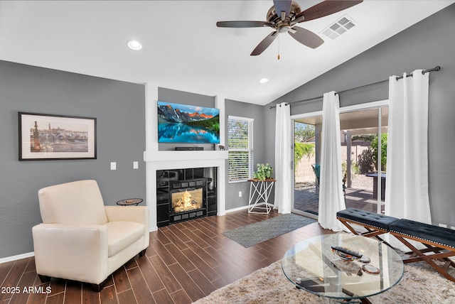 living room featuring lofted ceiling, baseboards, a tiled fireplace, recessed lighting, and ceiling fan