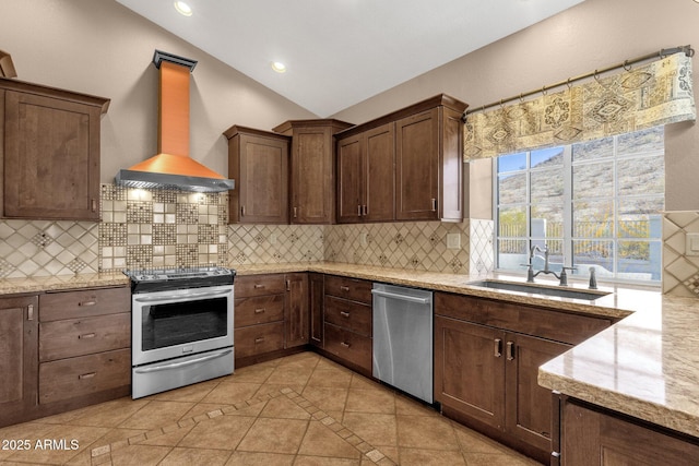 kitchen featuring exhaust hood, lofted ceiling, stainless steel appliances, and decorative backsplash