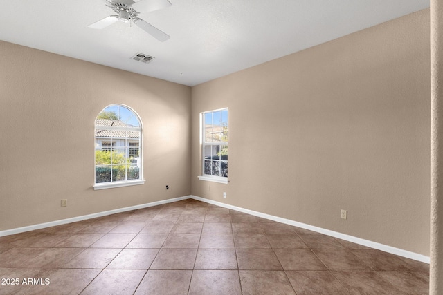 tiled empty room with ceiling fan