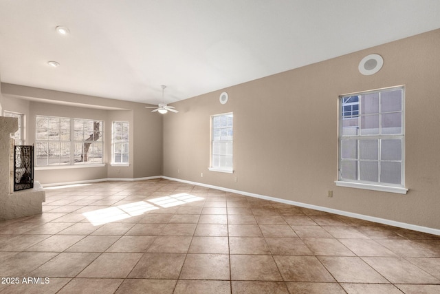 tiled spare room featuring ceiling fan