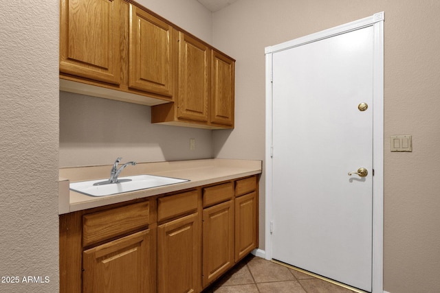 kitchen with sink and light tile patterned flooring