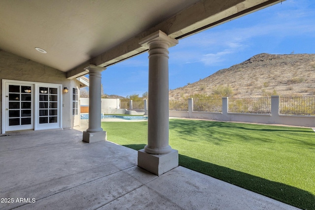 view of patio / terrace featuring a mountain view and a fenced in pool