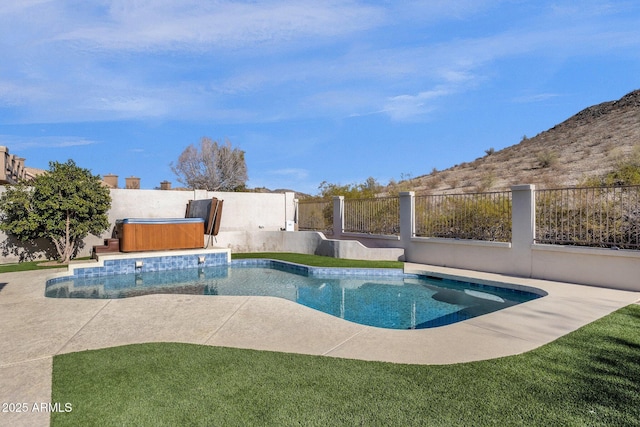 view of pool with a hot tub