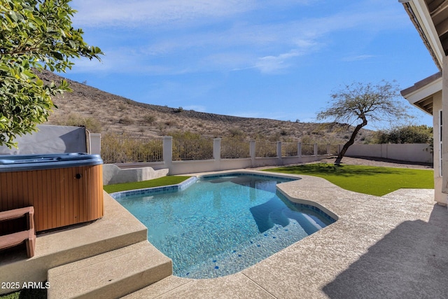 view of swimming pool featuring a mountain view, grilling area, a patio area, and a hot tub