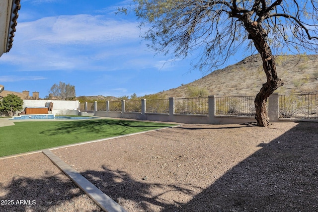 view of yard with a fenced in pool and a mountain view