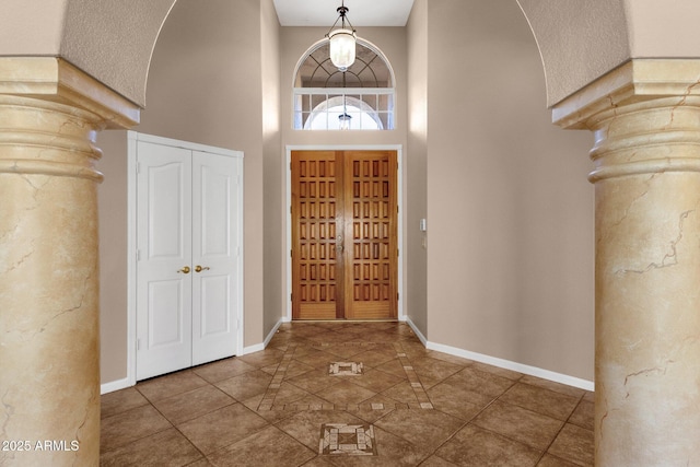 foyer entrance featuring a towering ceiling