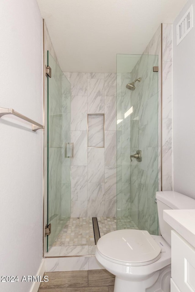 4302 N 80th Ln, Phoenix, AZ 85033 - bathroom featuring toilet, a marble finish shower, and vanity