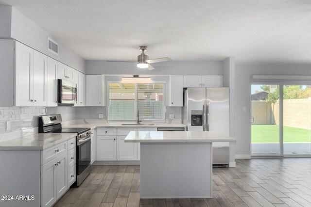 4302 N 80th Ln, Phoenix, AZ 85033 - kitchen with appliances with stainless steel finishes, a sink, light countertops, and tasteful backsplash