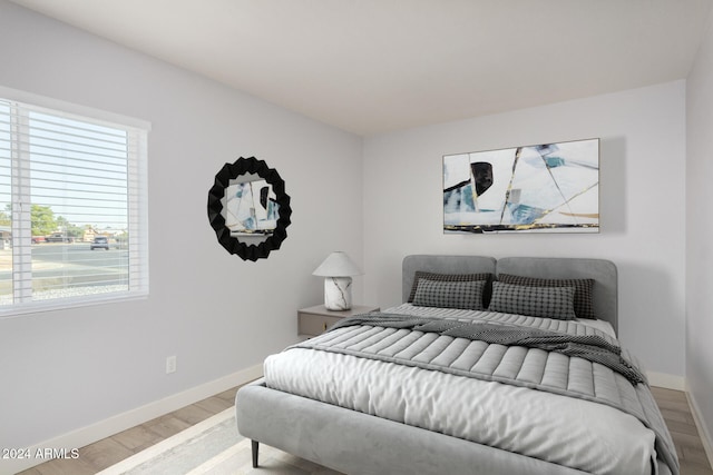 4302 N 80th Ln, Phoenix, AZ 85033 - bedroom featuring baseboards, multiple windows, and wood finished floors