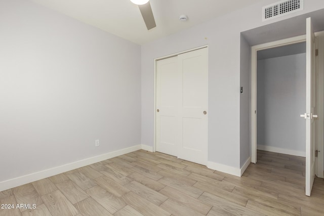 4302 N 80th Ln, Phoenix, AZ 85033 - unfurnished bedroom with light wood-style floors, baseboards, a closet, and ceiling fan