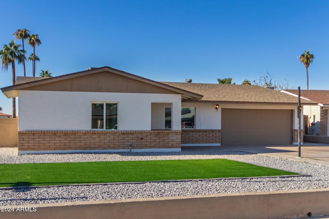 4302 N 80th Ln, Phoenix, AZ 85033 - single story home featuring brick siding, an attached garage, concrete driveway, and a front yard