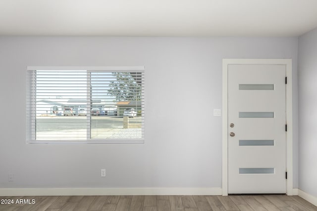 4302 N 80th Ln, Phoenix, AZ 85033 - entryway with baseboards and light wood-style flooring