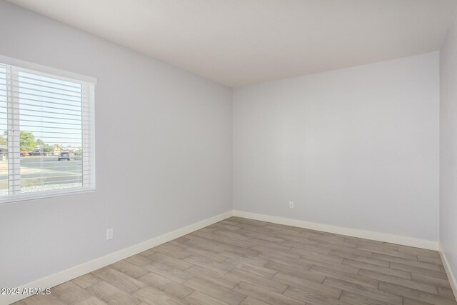 4302 N 80th Ln, Phoenix, AZ 85033 - spare room featuring light wood finished floors and baseboards