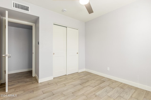 4302 N 80th Ln, Phoenix, AZ 85033 - unfurnished bedroom featuring light wood-type flooring, baseboards, a closet, and ceiling fan