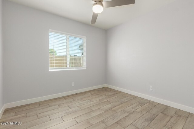 4302 N 80th Ln, Phoenix, AZ 85033 - unfurnished room with light wood-type flooring, ceiling fan, and baseboards
