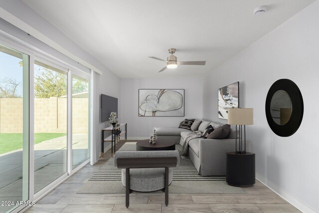 4302 N 80th Ln, Phoenix, AZ 85033 - living area with ceiling fan, light wood-style flooring, and baseboards