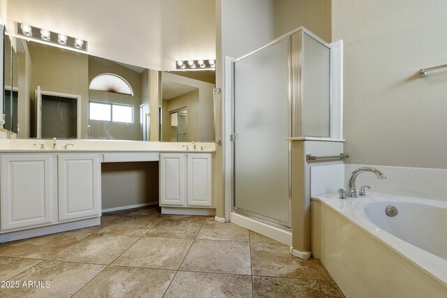 full bathroom featuring a garden tub, a sink, a shower stall, and double vanity