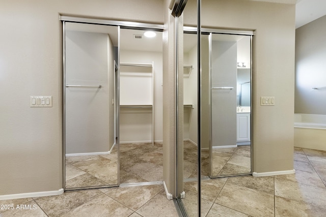 bathroom with baseboards, visible vents, and tile patterned flooring