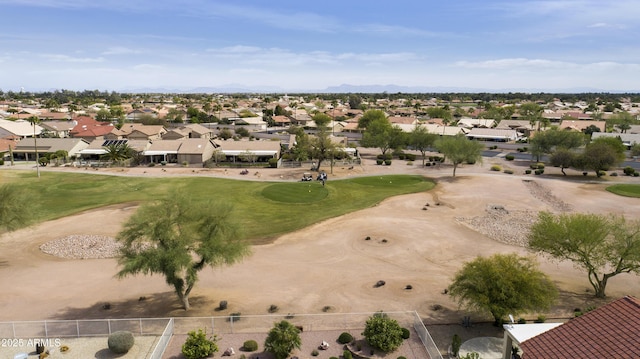 drone / aerial view featuring view of golf course, a mountain view, and a residential view