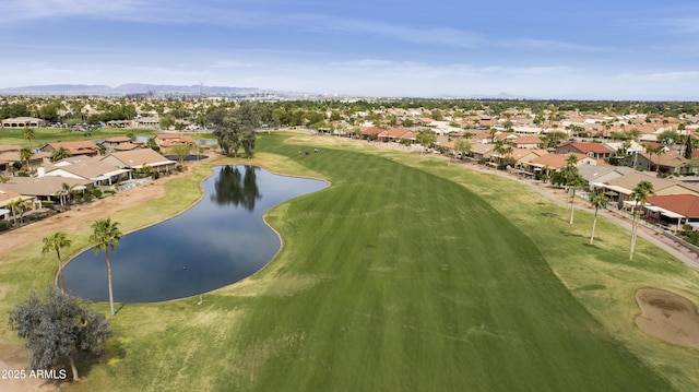 drone / aerial view featuring a water and mountain view, golf course view, and a residential view