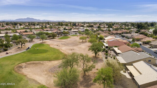 drone / aerial view featuring a mountain view, a residential view, and view of golf course