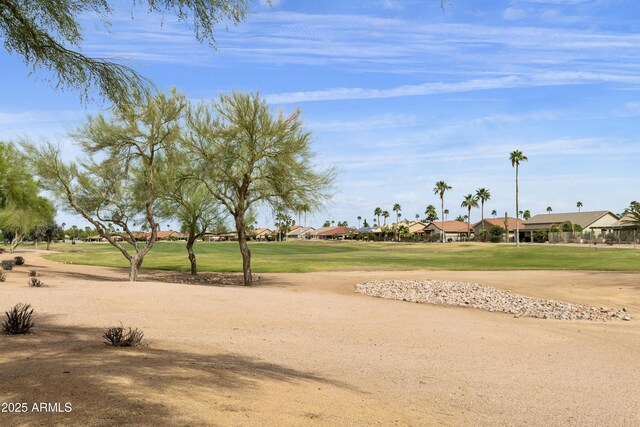 surrounding community featuring a residential view, a lawn, and view of golf course