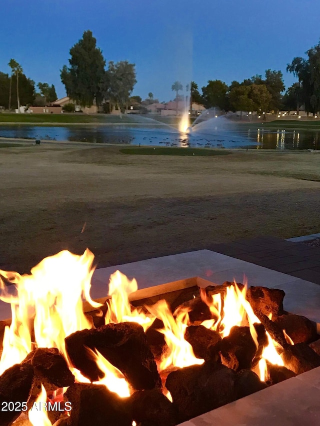 view of water feature with a fire pit