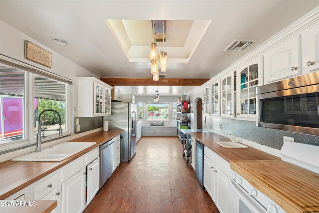 12501 E Cloud Rd, Chandler, AZ 85249 - kitchen featuring visible vents, white cabinets, a sink, appliances with stainless steel finishes, and a tray ceiling