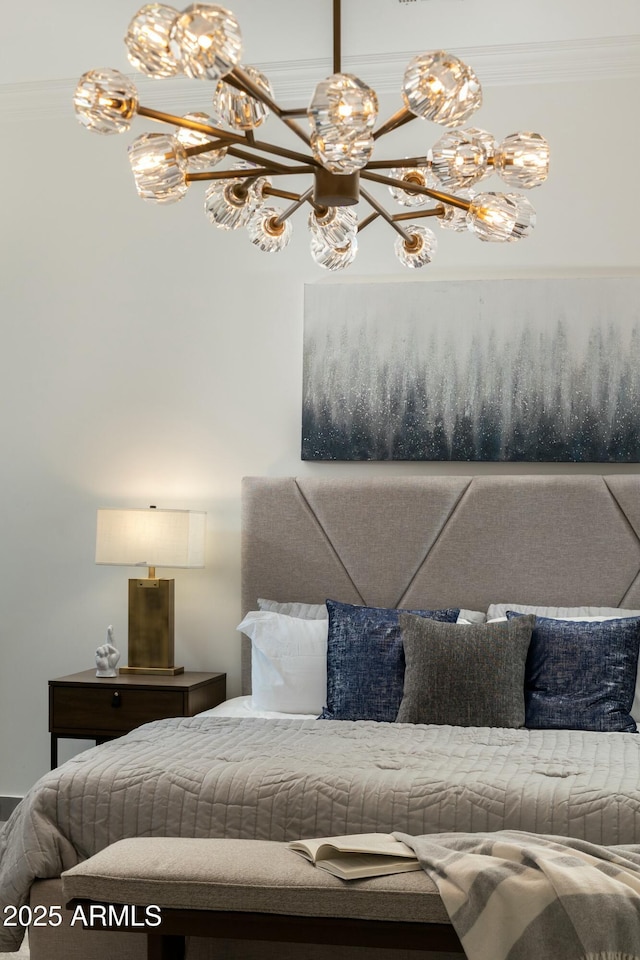 bedroom with a chandelier and crown molding