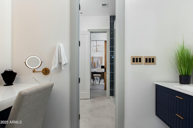 bathroom with concrete flooring, visible vents, and vanity